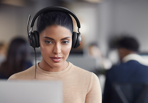 Women at desk wearing Jabra Evolve2 65 headset