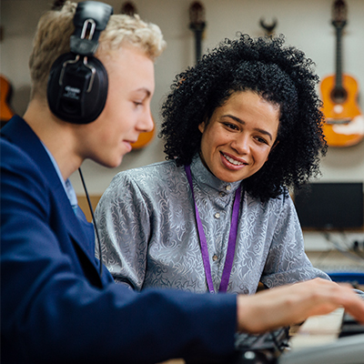 Student and teacher using the new Apple Mac in music class