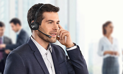 Man wearing Jabra Engage headset taking a call