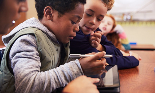 Students observing student using windows 10 mobile device