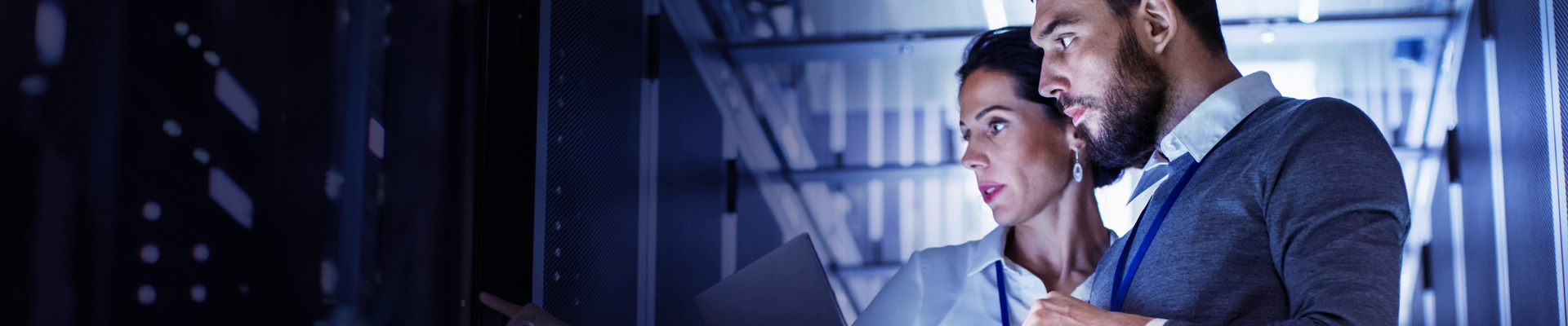 Male and female IT engineers in server room