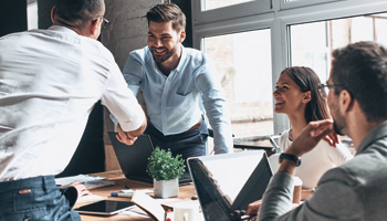 BT IT specialists shaking hands with customers