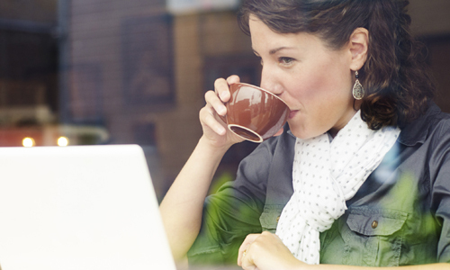 Customer using IT equipment in coffee shop