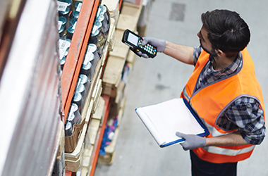 Warehouse staff asset tagging stock