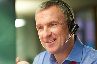 Man on phone to customer discussing IT service wrap