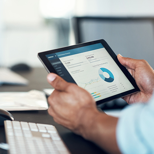 Teacher using mobile device to manage school systems
