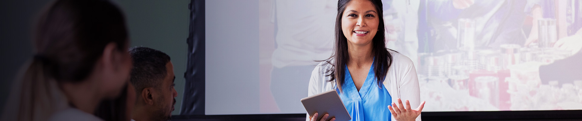 teacher with iPad delivering class