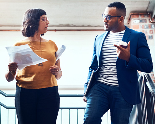 Man and Women social distancing walking into an office