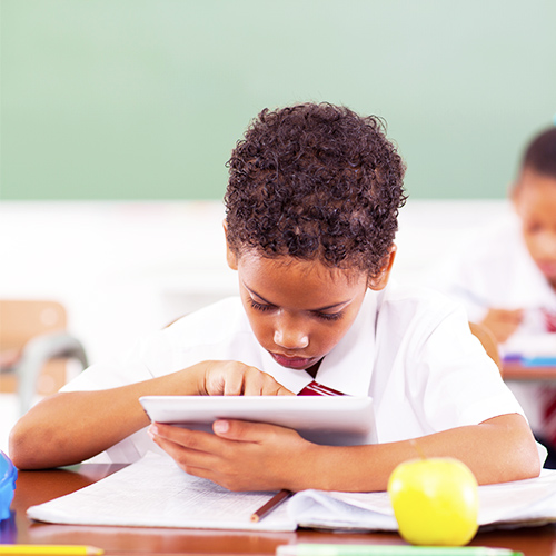 Pupils in a classroom using technology devices