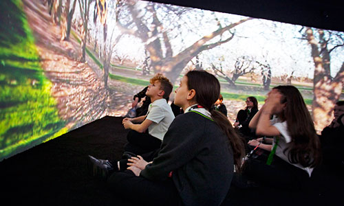students watching video on 360 walls