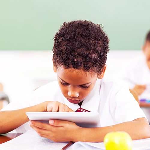 School boy using a 1:1 device