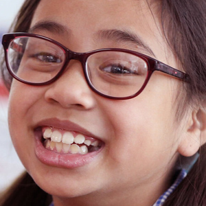 Smiling young girl wearing glasses