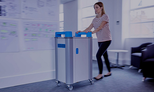 Teacher pushing charging trolly to classroom