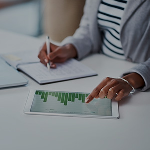 Teacher working out finances on tablet