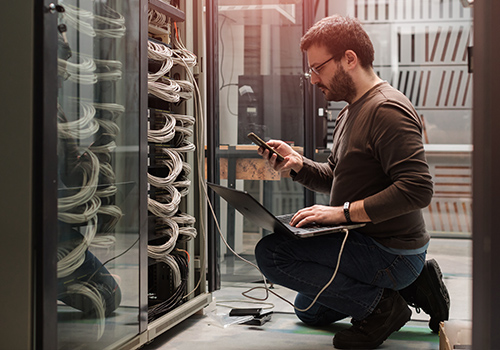 Male engineer configuring server