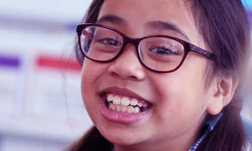 Young girl in school uniform smiling