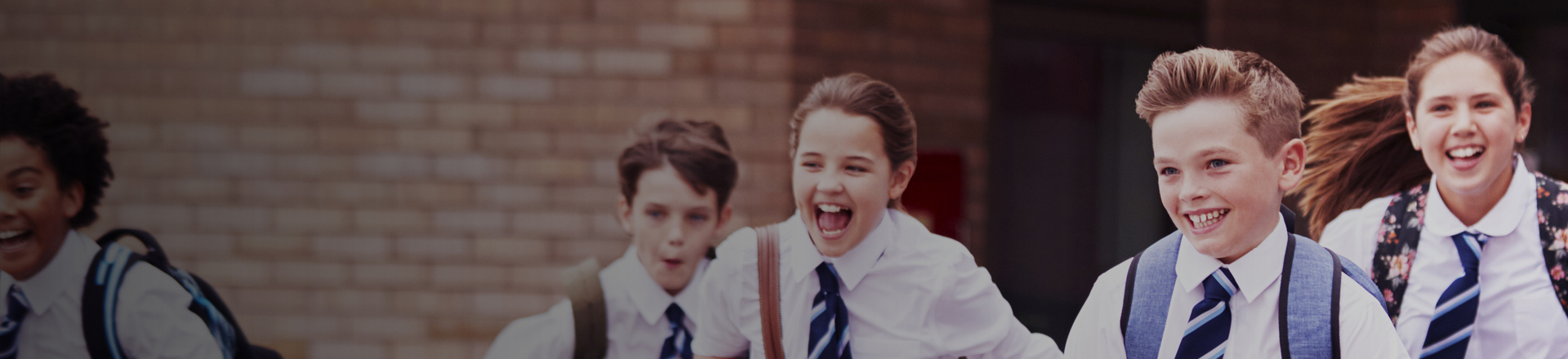 School pupils in school uniform running